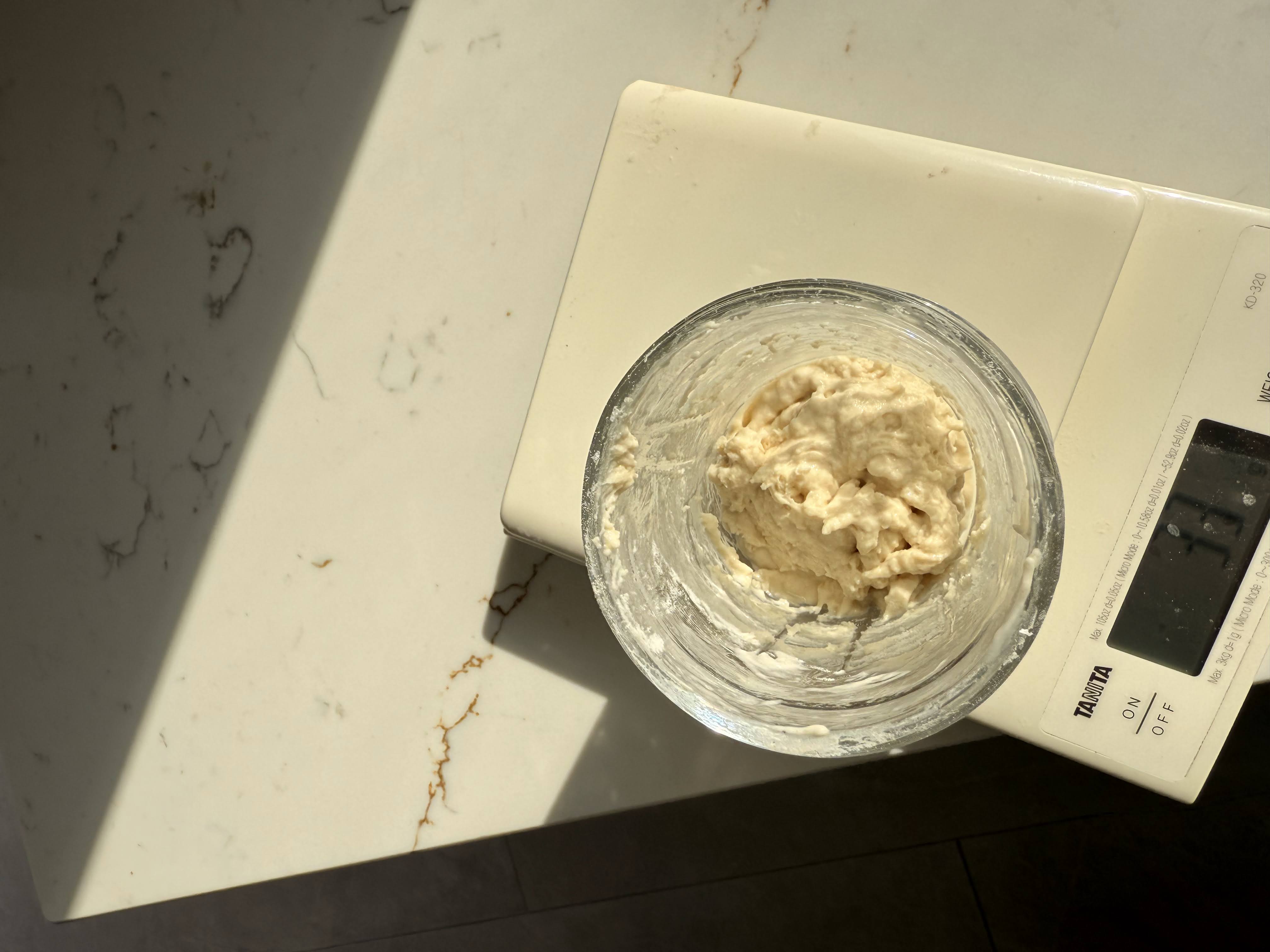 Sourdough starter mixed to a thick paste consistency in a jar